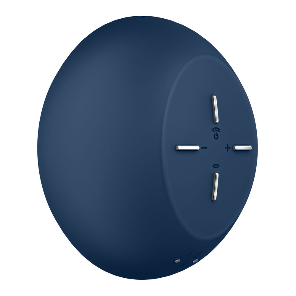 The Satisfyer Air Power 4 in navy is a circular wireless speaker with a smooth surface. It features four silver control buttons in a cross pattern, including plus and minus for volume, with a small Wi-Fi icon and power button between the controls.