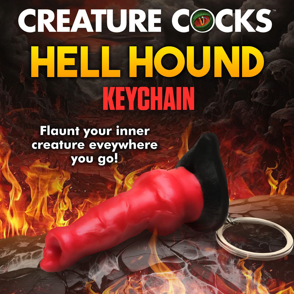 A red, sculpted keychain resembling a mythical horn with black details is set against a fiery backdrop. It reads Creature Cocks Hell-Hound Keychain - Novelty Fantasy Dildo Keyring, inviting you to flaunt your inner creature and embrace fantasy roleplay everywhere!.