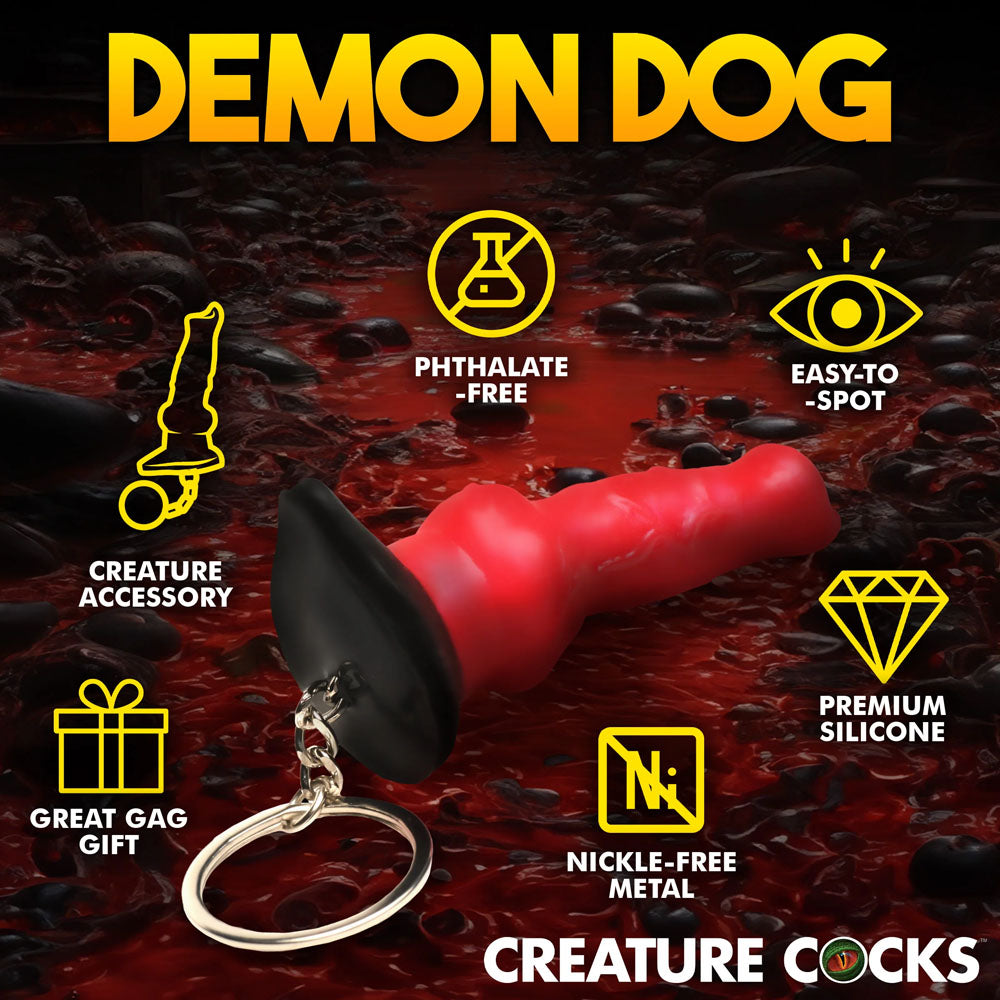 The Creature Cocks Hell-Hound Keychain is a red and black dog-shaped accessory against a dark red background. It features Phthalate-Free, Easy-to-Spot, and Premium Silicone qualities, making it ideal for fantasy roleplay or as a Great Gag Gift.
