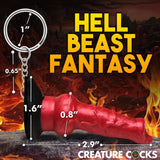 The Creature Cocks Hell-Hound Keychain features a red, horn-like novelty fantasy dildo against a fiery backdrop with HELL BEAST FANTASY and CREATURE COCKS text. Perfect for horror enthusiasts or fantasy roleplayers, it measures 2.9 inches and includes loops for easy attachment.