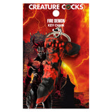The Creature Cocks Fire Demon Keychain is a novelty fantasy dildo keyring with black and red textured packaging featuring a horned demon before a blazing scene. Ideal for fantasy roleplay and mythical sex adventures.