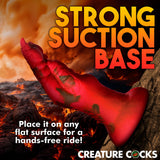 A red, textured Creature Cocks Demon Claw Fisting Silicone Dildo with a strong suction base stands out against a fiery backdrop. Perfect for fantasy roleplay and hands-free thrill on any flat surface, its strength and durability evoke the allure of demon claws.