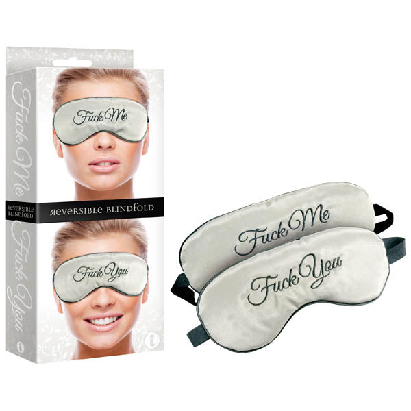 The Fuck Me/Fuck You Padded Reversible Blindfold features fun embroidery, with Fuck Me on one side and Fuck You on the other. It is shown outside packaging, revealing both phrases on the comfortable fitting blindfold, modeled with a smile on the daring Fuck Me side.
