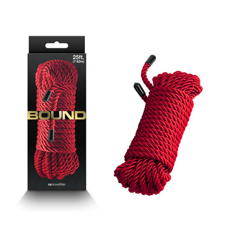 The packaging showcases a red rope bundle on a dark background with gold text 7.6 metre and BOUND. Made of durable polyester fibre, the rope has black plastic ends. The textured gray box features nsnovelties brand at the bottom.
