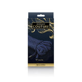 The image displays the Bondage Couture Rope - Blue by NS Novelties. Featured in a dark blue box with gold accents, it highlights a coiled 7.6-meter blue rope. Bondage Couture is elegantly printed on the black and gold packaging, making it a stylish addition to your collection.