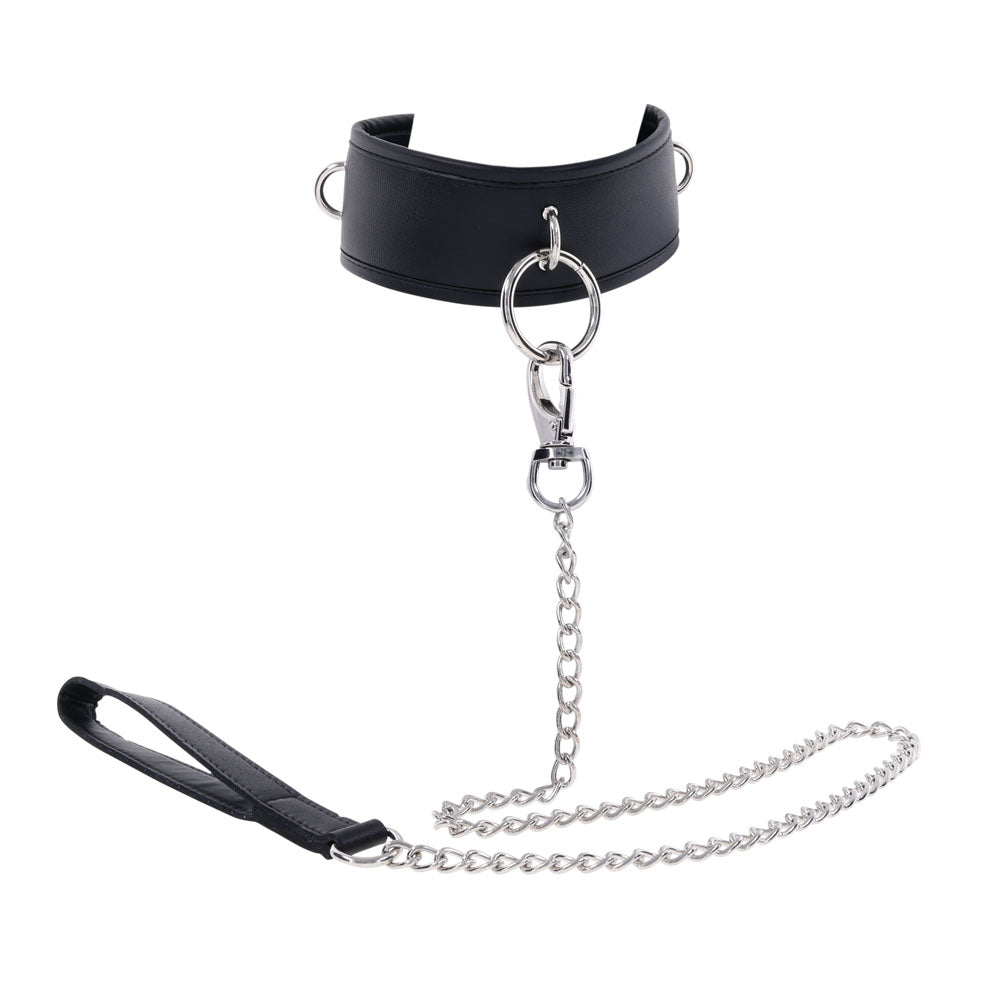The EDGE Collar & Leash is a black faux leather neck restraint with a large metal O-ring, featuring a silver chain lead and lobster clasp. It includes a black leather handle for grip and two side D-rings for versatility.