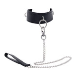 The EDGE Collar & Leash is a black faux leather neck restraint with a large metal O-ring, featuring a silver chain lead and lobster clasp. It includes a black leather handle for grip and two side D-rings for versatility.