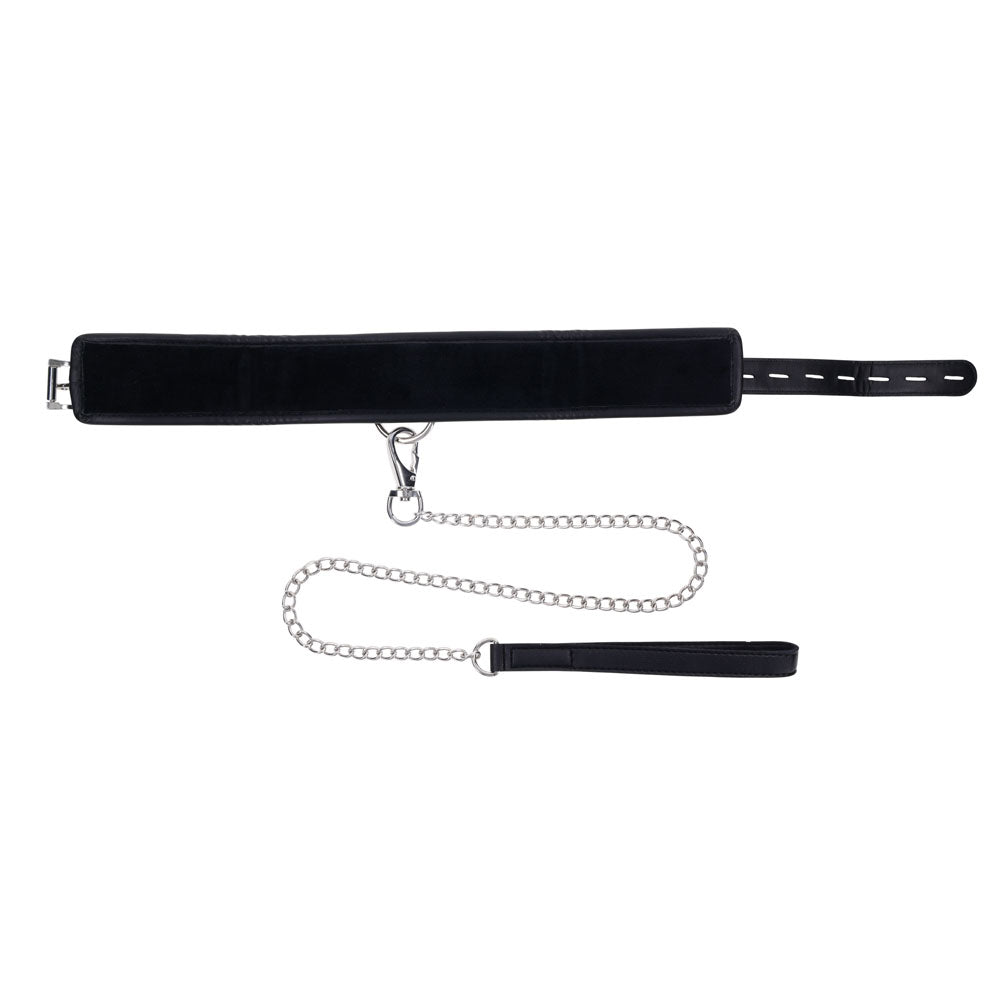 The EDGE Collar & Leash features a black faux leather padded collar with an adjustable belt buckle and a silver metal chain leash, complete with a clasp and black loop handle. Ideal for adult restraint play, it contrasts beautifully against the white background.