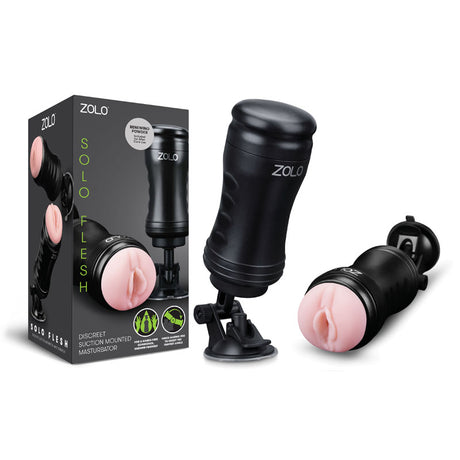 The Zolo Solo Flesh Vagina Stroker, suction-mounted for shower use, features a black exterior with a pink opening for male users. Its silicone interior comes in a box adorned with green and white text images and descriptions.