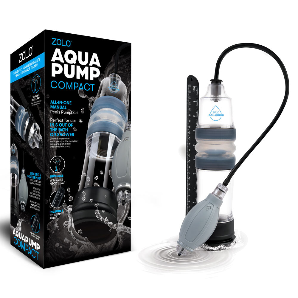 The image features the Zolo Aquapump Compact - Clear Water Penis Pump, a sleek manual pump with a clear chamber, black base, and gray bulb pump. Positioned beside its packaging, it emphasizes the waterproof design perfect for bath or shower use.