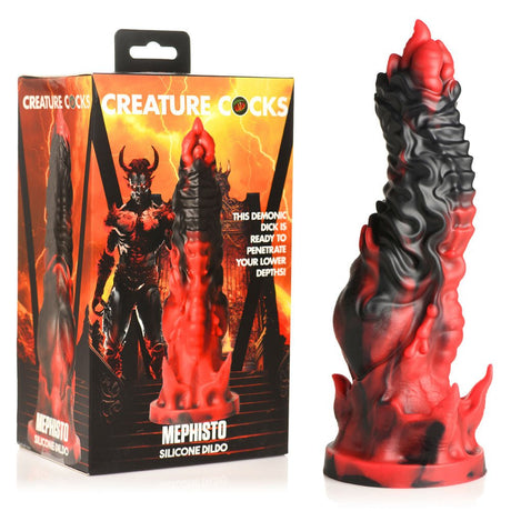 The Creature Cocks Mephisto Red/Black 18.5 cm Fantasy Dildo, in premium silicone with a flame-like design, sits beside its box with a fiery background and horned demon, offering an otherworldly allure.