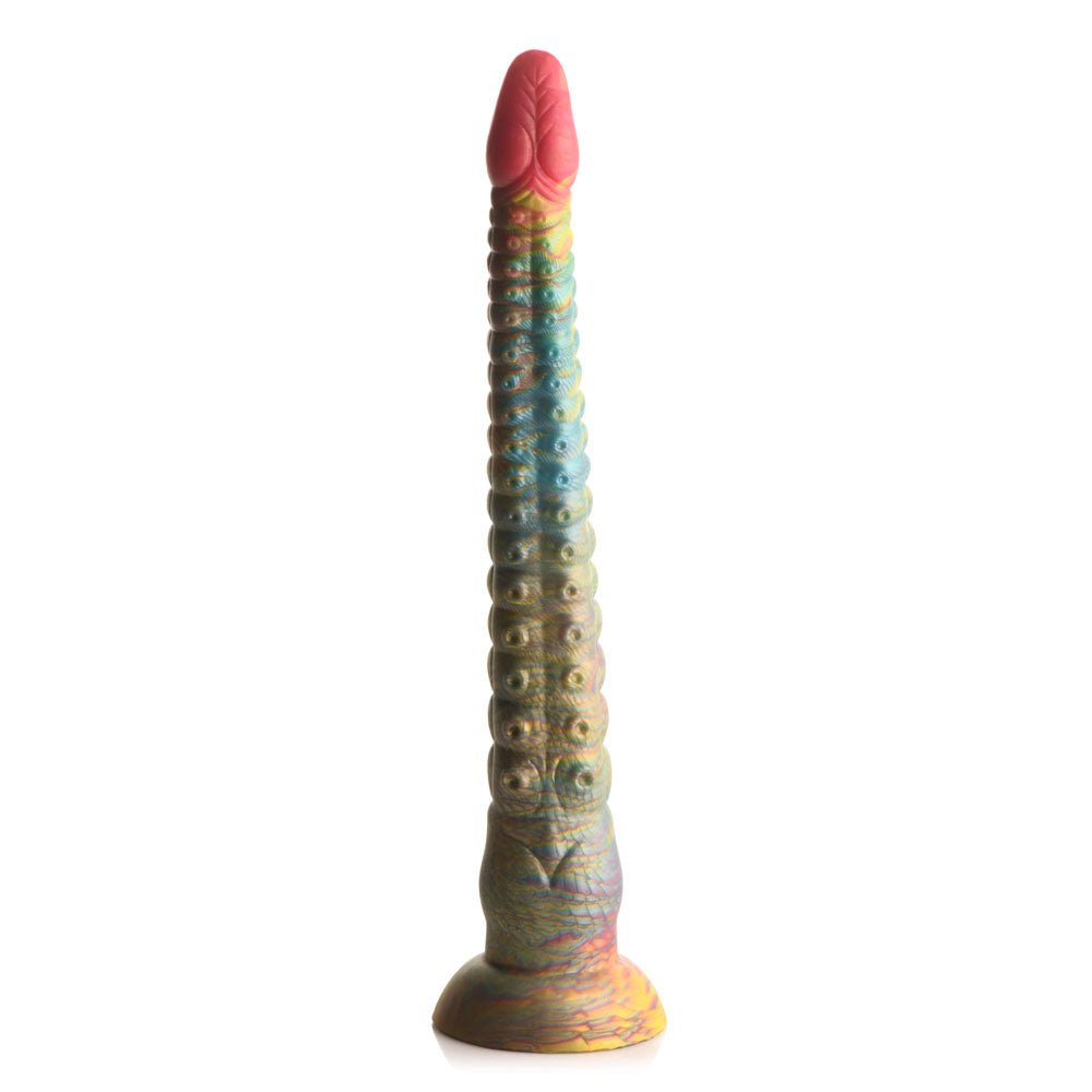 The Creature Cocks Tenta-Dick is a 32 cm multicolored tentacle fantasy dildo with a bulbous red tip, transitioning to a yellow base with scale-like patterns, crafted from phthalate-free silicone. It features raised circular bumps and a wide suction-cup base for stability, blending vibrant reds, blues, greens, and yellows.